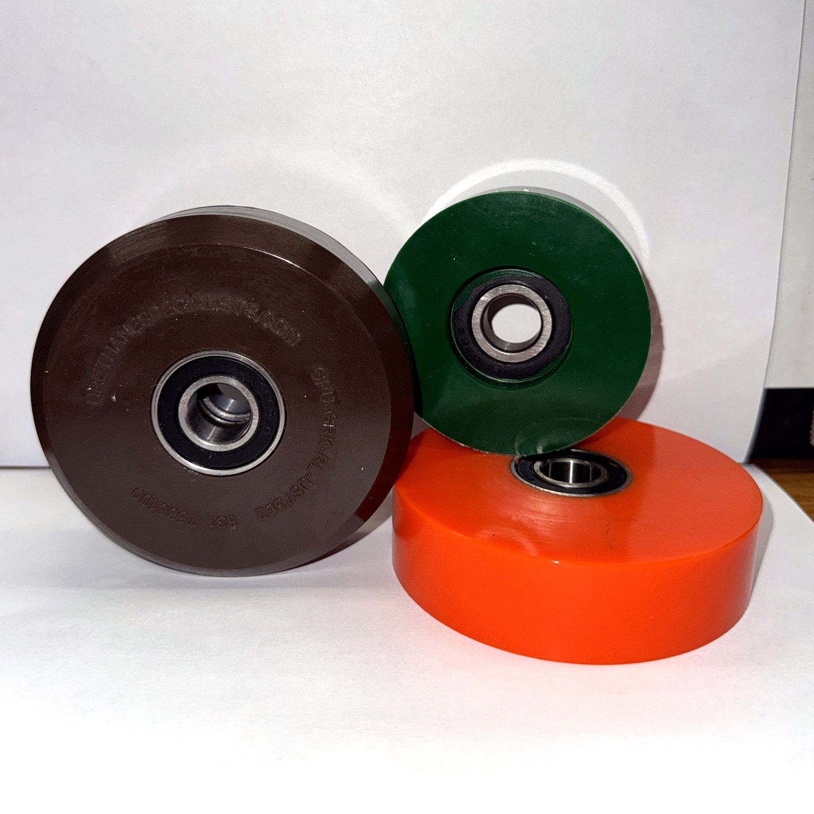 Brown, green and orange AeroPorter urethane wheels for baggage handling systems