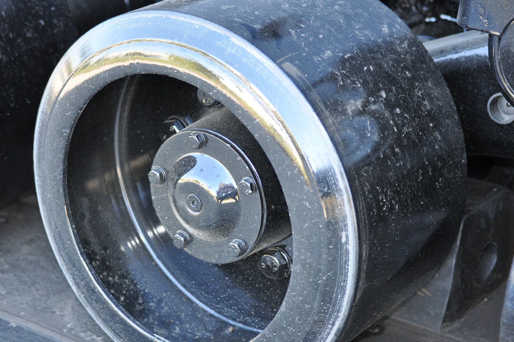 Close up of a bogie wheel mounted on a track tractor