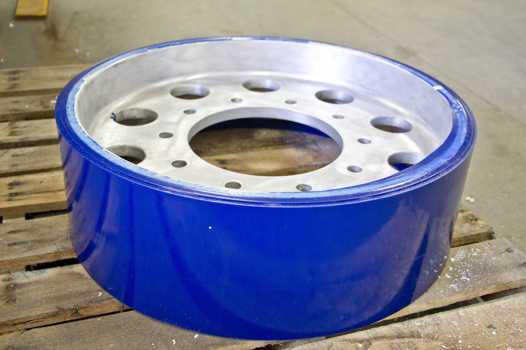 Rebuilt bogie wheels with blue Agrathane urethane on a pallet