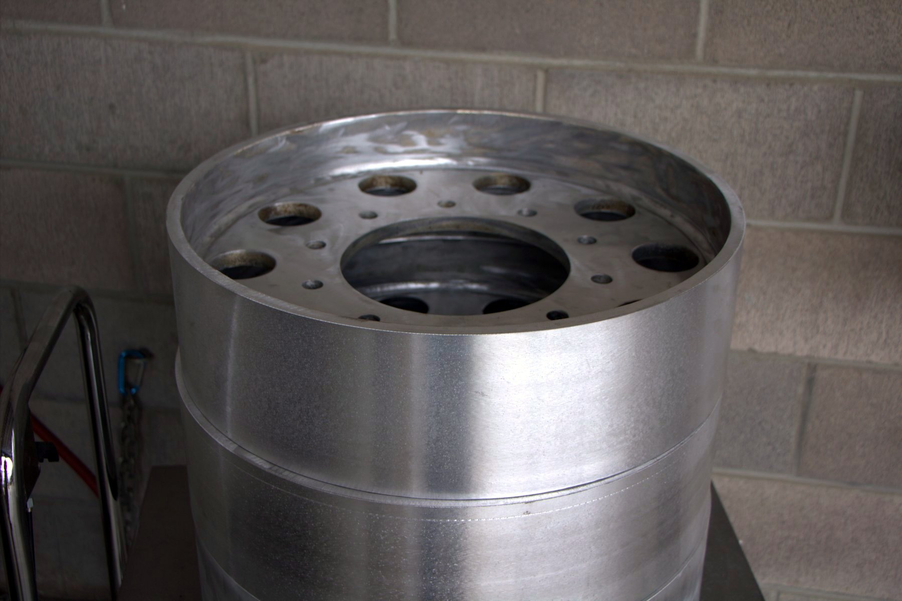 Bogie wheel stripped to the bare steel hub before rebuild