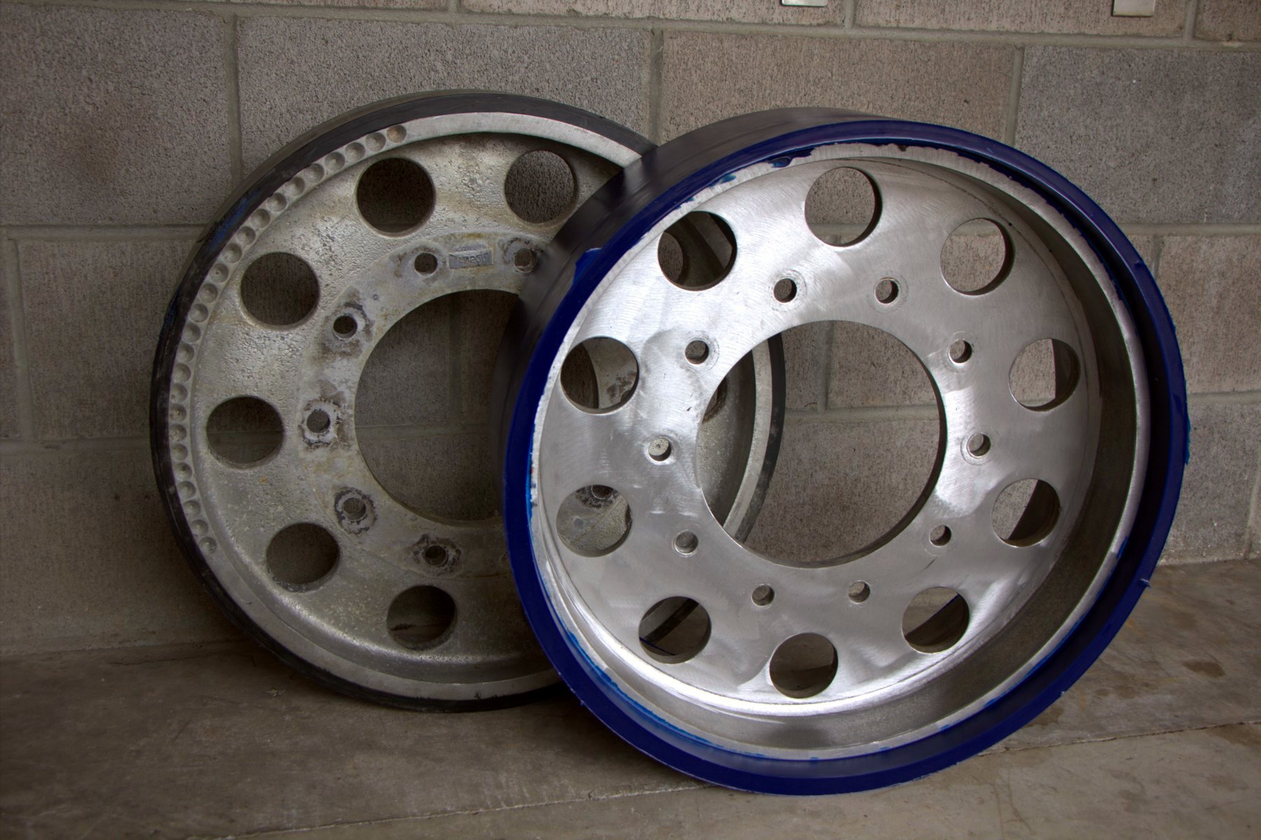 Bogie wheels before and after urethane rebuild
