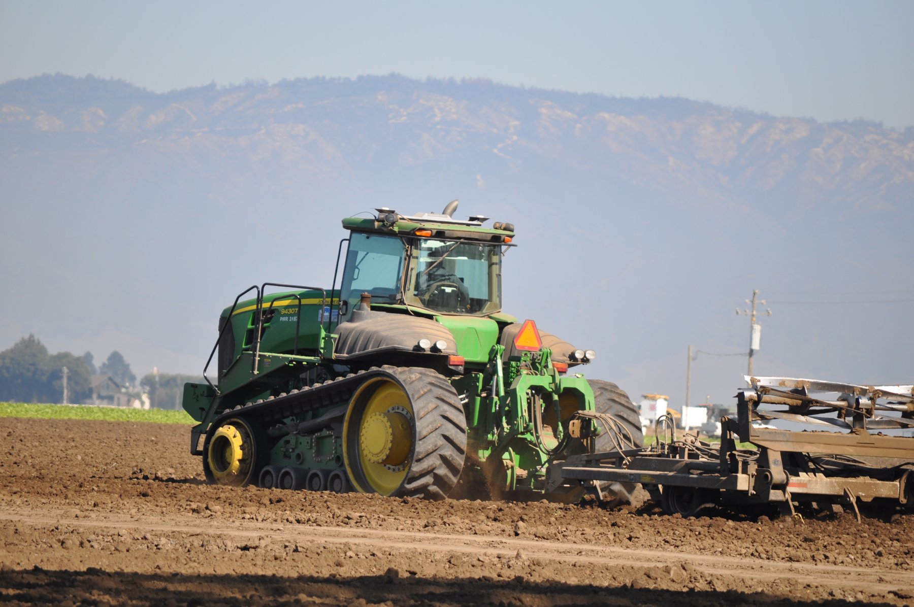 John Deere track tractor working a Salinas Valley field
