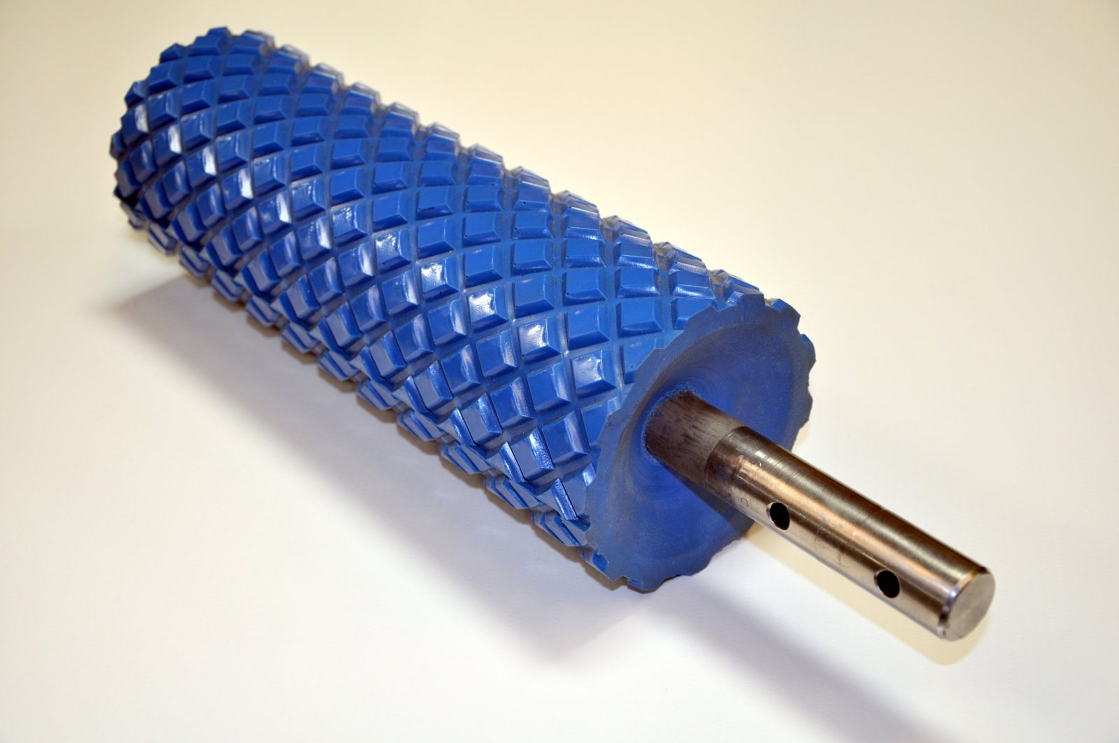 Blue diamond pattern urethane roller on a steel shaft