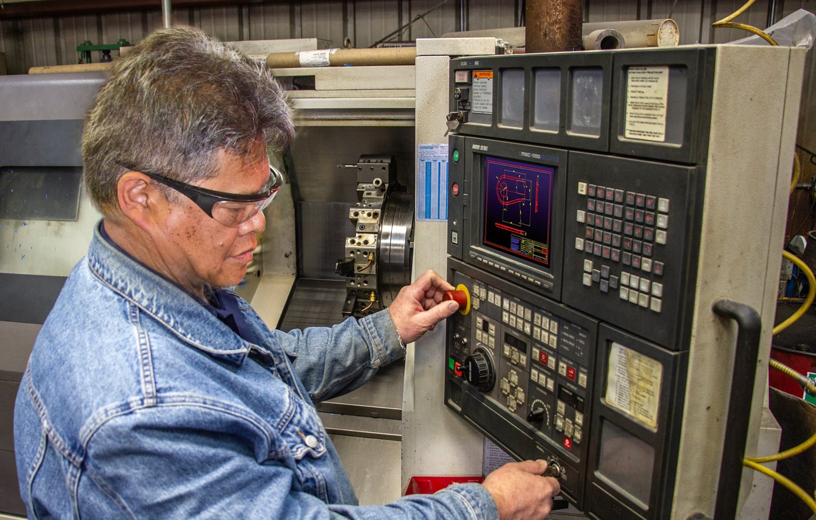 Technician at the CNC control cutting a urethane mold