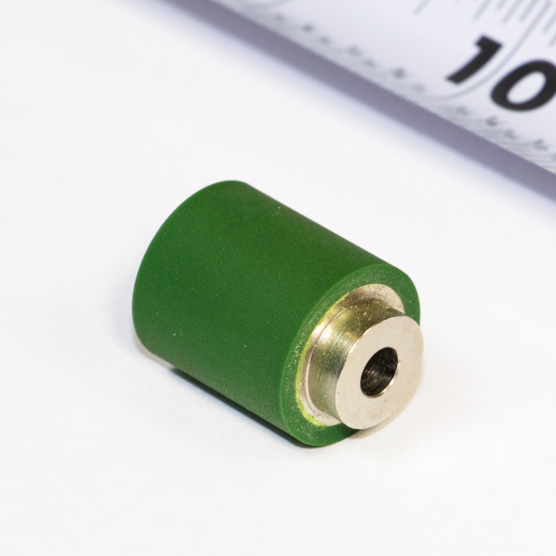 Green urethane roller bonded to a steel core